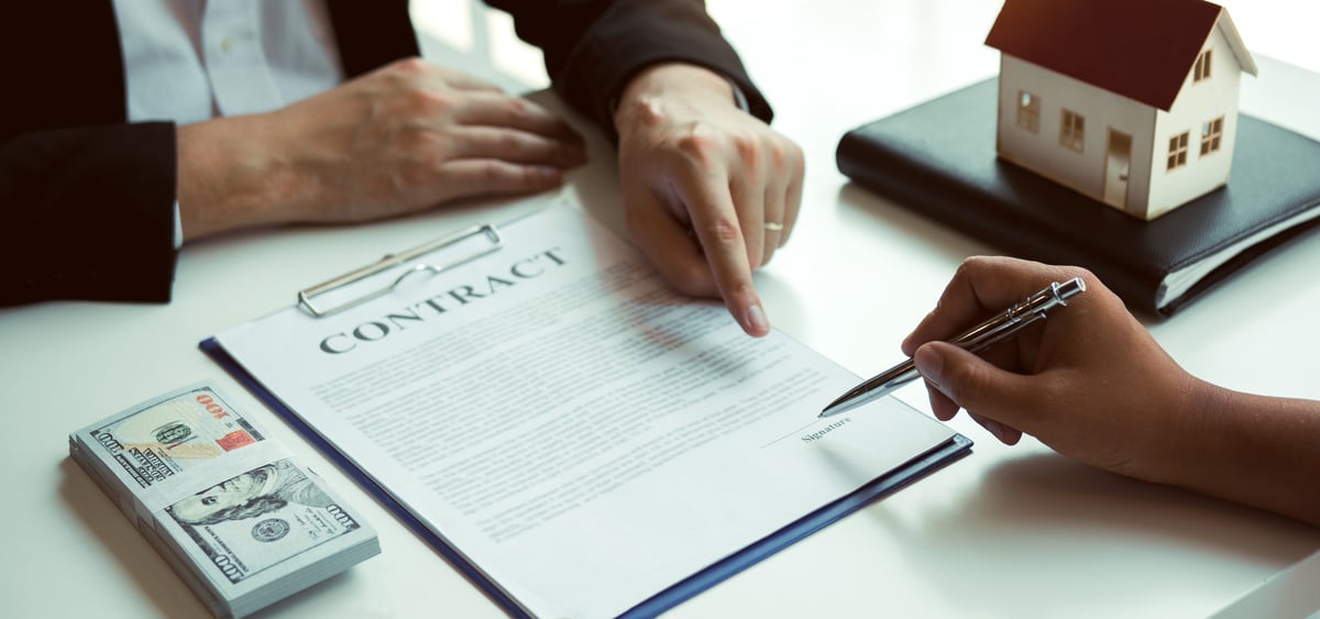 Investor Signing the Contract to Buy the House